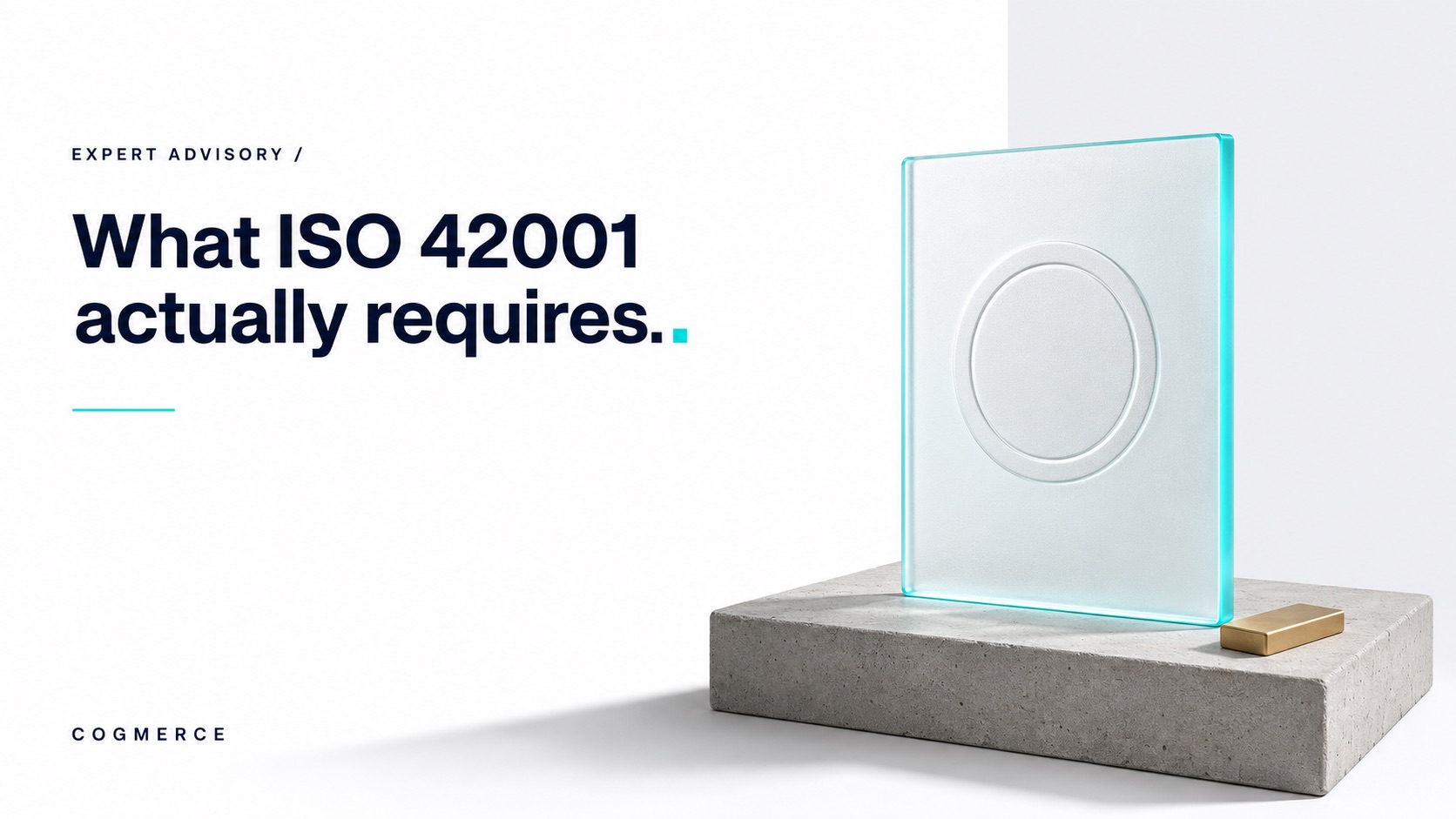 A frosted glass tablet pressed with a blind-embossed plain ring seal on a concrete podium, a small gold bar beside it